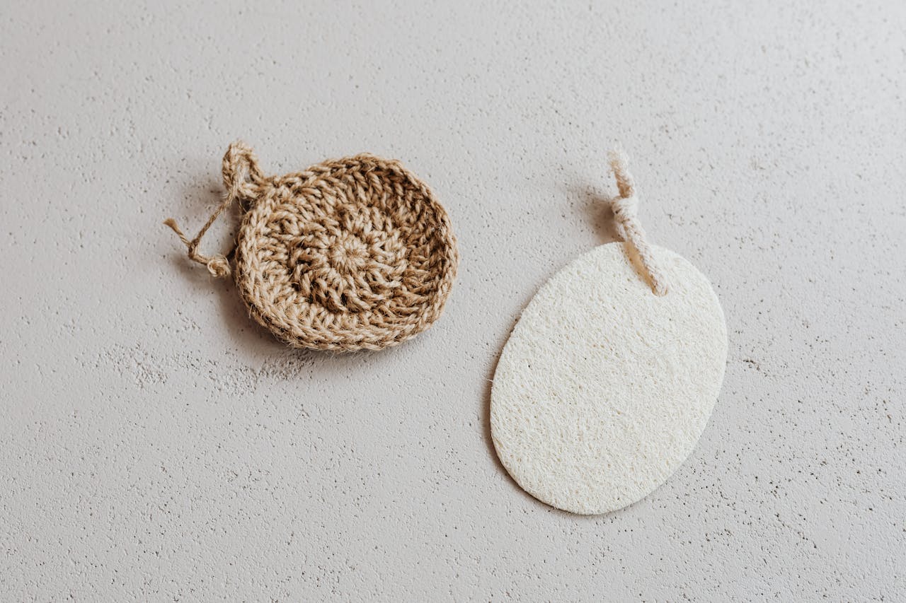 Pair of eco-friendly handmade scrubbers crafted from natural fibers and loofah, perfect for zero waste living.