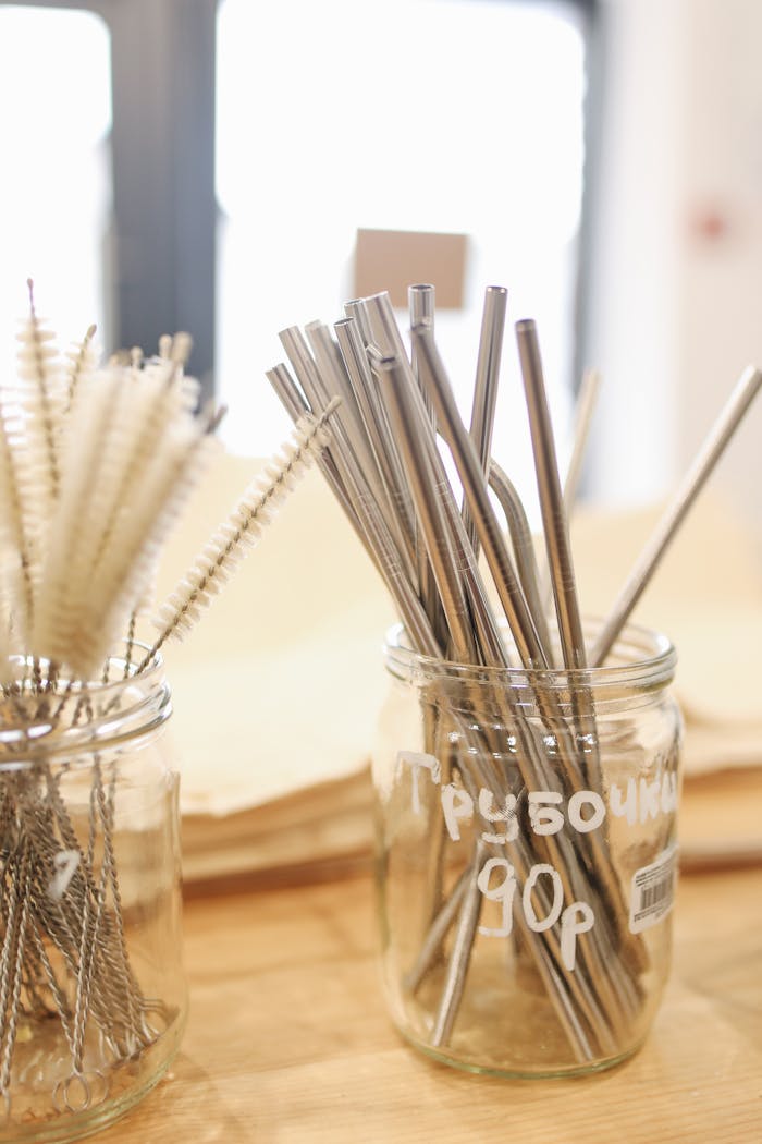 Metal straws and cleaning brushes on display promoting zero waste and sustainability.