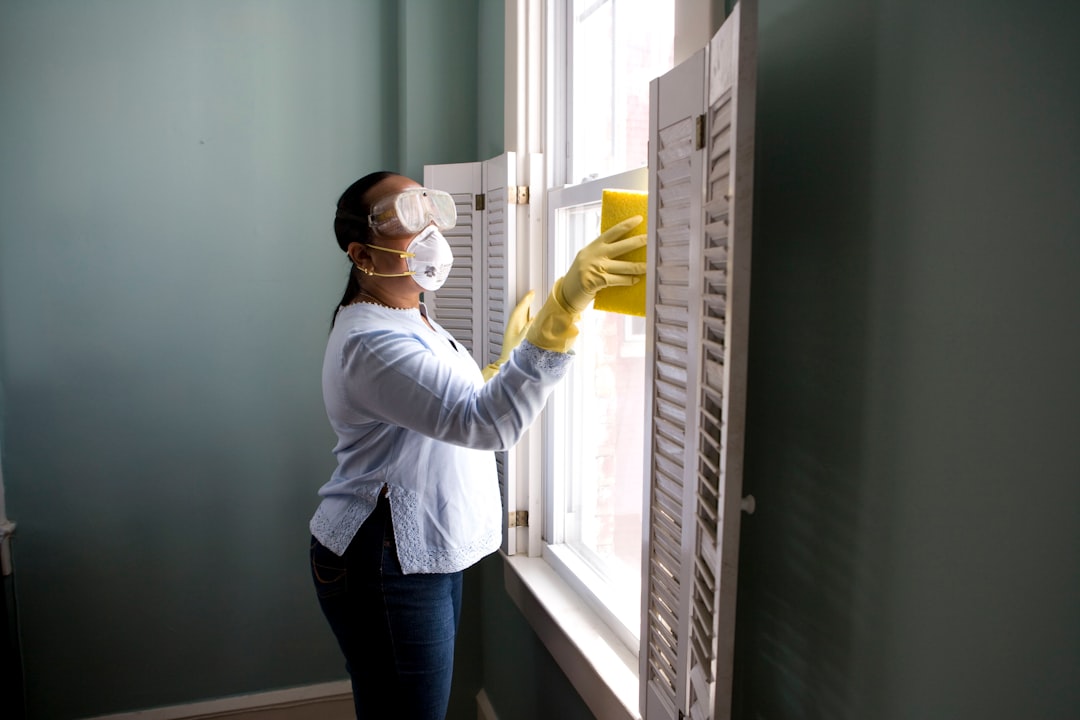 services-03 When renovating a home, you should use a damp sponge or cloth to clean dust collected on a window sill, as the dust may contain asbestos or lead-based paint. Home maintenance is an ongoing process for any homeowner, and here we see an African- American woman who’d taken a damp sponge to her window’s frame, in order to remove accumulated dust particulates. Note how the homeowner had donned a pair of waterproof gloves, a facemask, and a pair of goggles, prior to beginning this task.